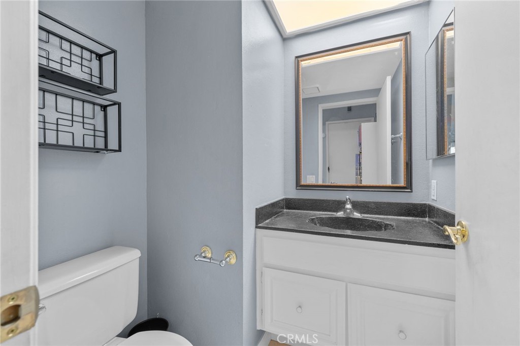 8264 Mondavi Place Rancho Cucamonga, CA 91730 - Photo 12 of 34 a bathroom with a granite countertop sink and a mirror