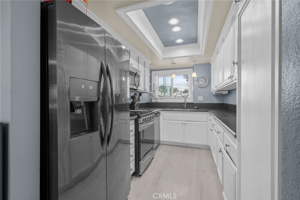 8264 Mondavi Place Rancho Cucamonga, CA 91730 - Photo 14 of 34 a kitchen with a refrigerator and a sink