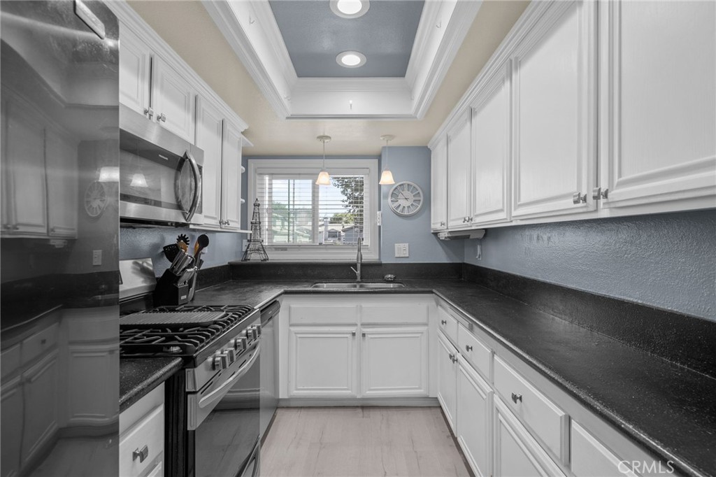 8264 Mondavi Place Rancho Cucamonga, CA 91730 - Photo 15 of 34 a kitchen with stainless steel appliances granite countertop a sink stove and cabinets