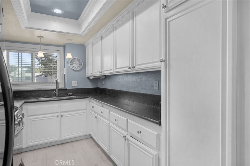 8264 Mondavi Place Rancho Cucamonga, CA 91730 - Photo 16 of 34 a kitchen with granite countertop white cabinets and a sink