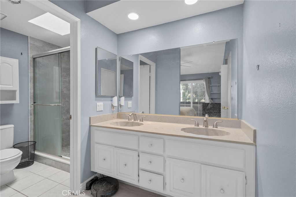 8264 Mondavi Place Rancho Cucamonga, CA 91730 - Photo 23 of 34 a bathroom with a double vanity sink toilet and shower