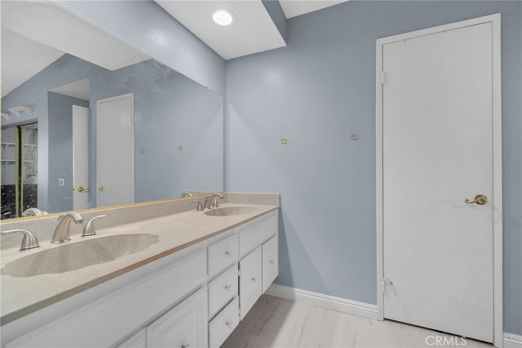 8264 Mondavi Place Rancho Cucamonga, CA 91730 - Photo 24 of 34 a bathroom with a double vanity sink and a mirror