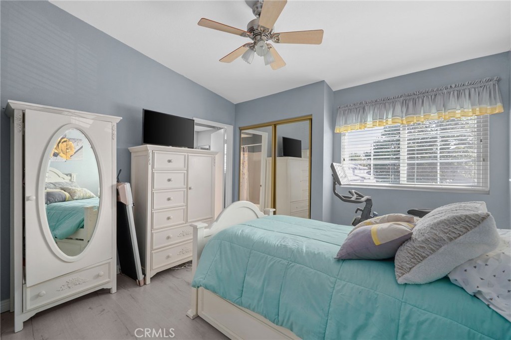 8264 Mondavi Place Rancho Cucamonga, CA 91730 - Photo 26 of 34 a bedroom with a bed a mirror and a window