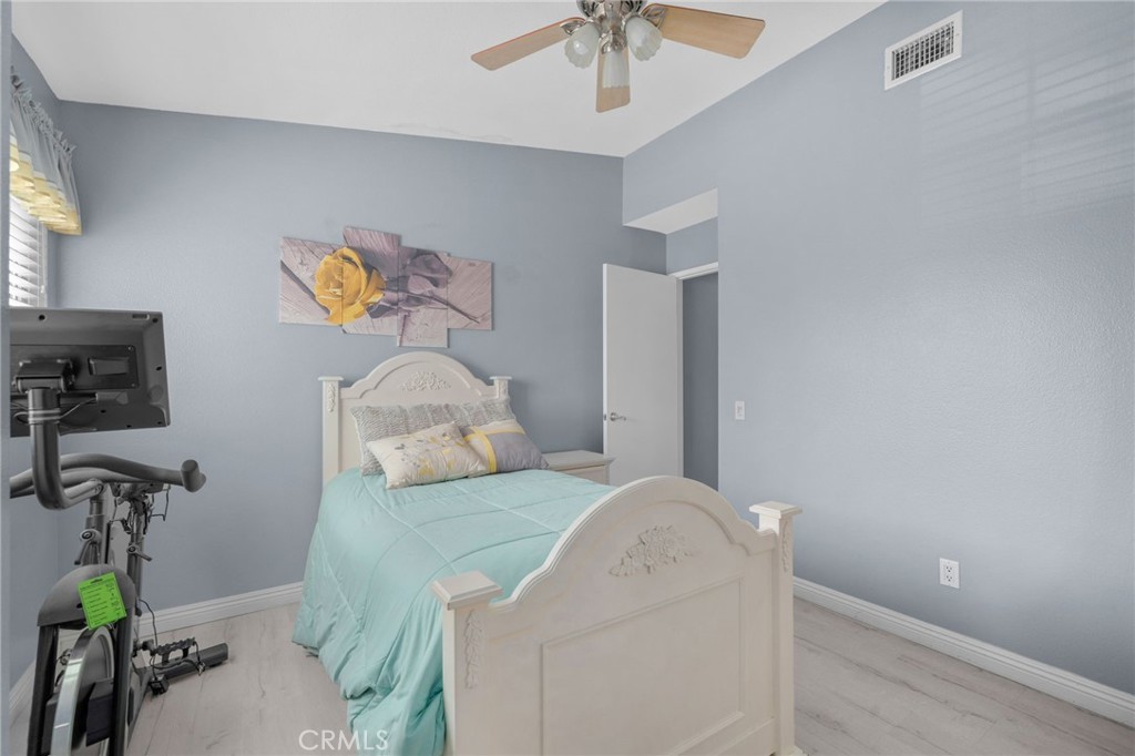 8264 Mondavi Place Rancho Cucamonga, CA 91730 - Photo 27 of 34 a bedroom with a bed and a chandelier