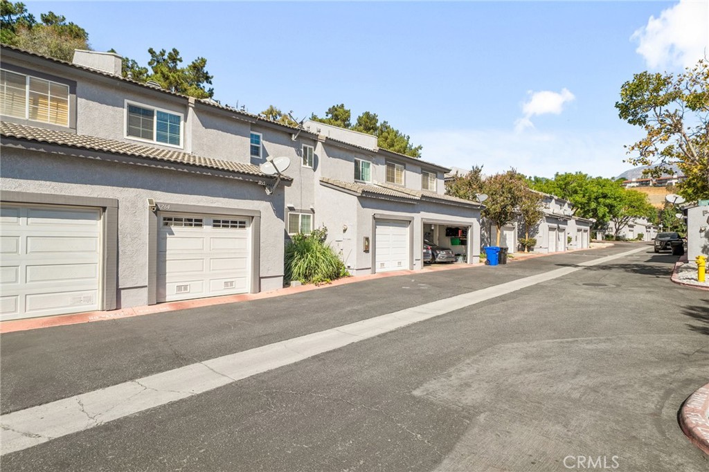 8264 Mondavi Place Rancho Cucamonga, CA 91730 - Photo 30 of 34 front view of a house with a street