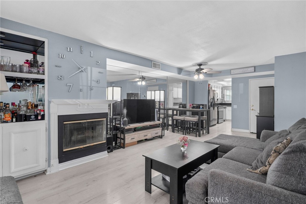 8264 Mondavi Place Rancho Cucamonga, CA 91730 - Photo 8 of 34 a living room with furniture a fireplace and a flat screen tv