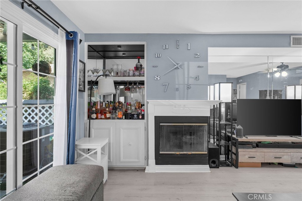8264 Mondavi Place Rancho Cucamonga, CA 91730 - Photo 9 of 34 a living room with furniture a fireplace and a large window