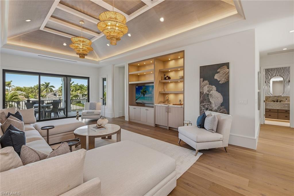 529 Neapolitan Way Naples, FL 34103 - Photo 23 of 26 a living room with furniture and a large window