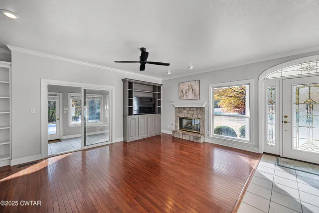 a view of empty room with wooden floor and fireplace