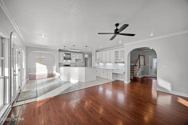 a kitchen with stainless steel appliances kitchen island granite countertop a sink and cabinets