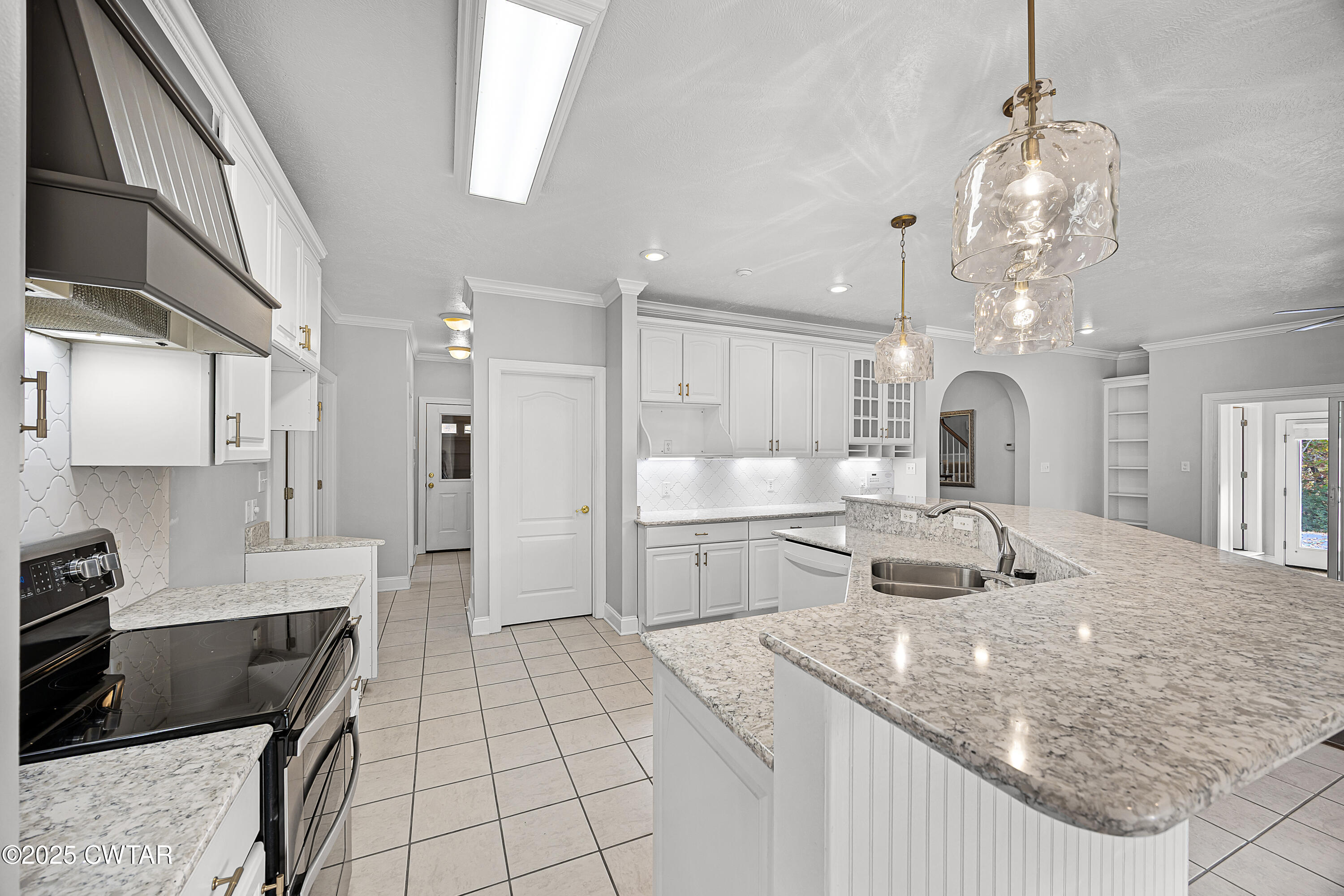 433 Sanders Bluff Road Three Way, TN 38343 - Photo 17 of 43 a kitchen with stainless steel appliances granite countertop a sink stove and refrigerator