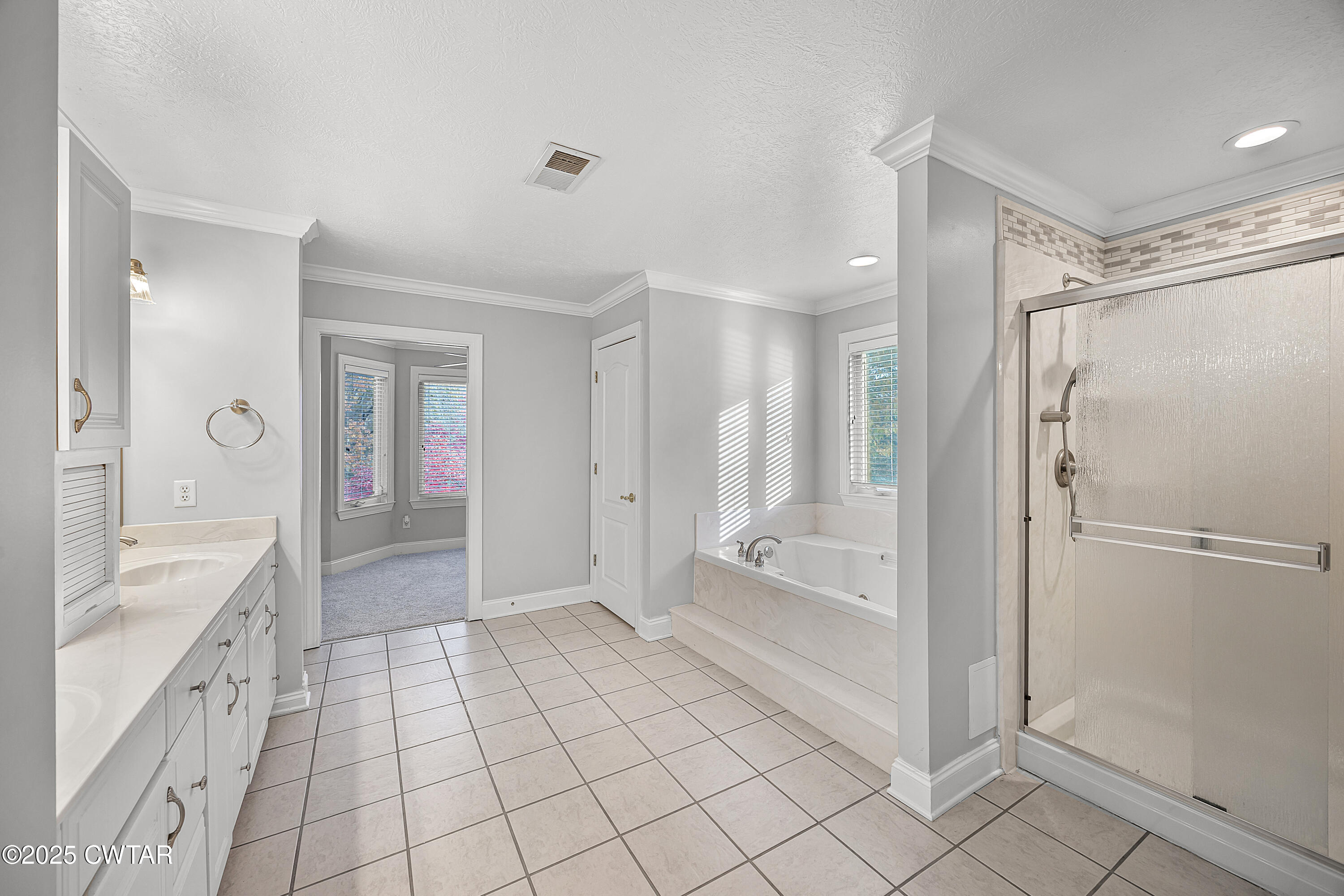 433 Sanders Bluff Road Three Way, TN 38343 - Photo 25 of 43 a spacious bathroom with a glass shower door and a glass door shower