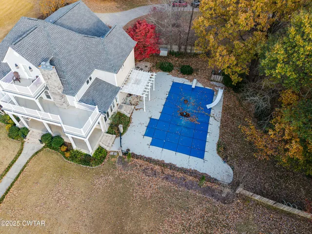 a view of a swimming pool with a garden and deck