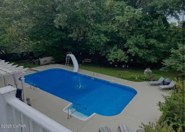 a front view of house with yard barbeque oven and outdoor seating