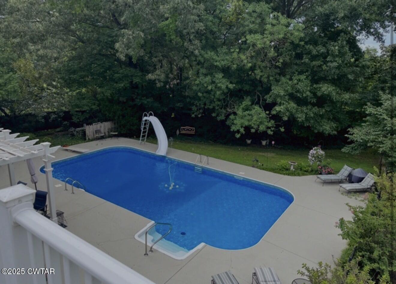 433 Sanders Bluff Road Three Way, TN 38343 - Photo 6 of 43 a view of a swimming pool with a garden and deck