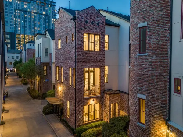 a view of a brick building next to a yard