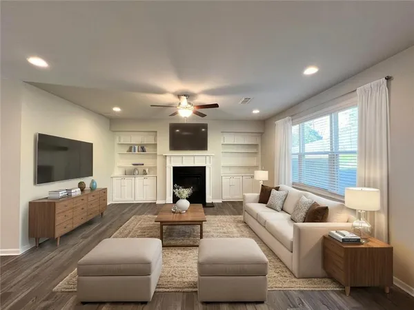 a living room with furniture a flat screen tv and a fireplace
