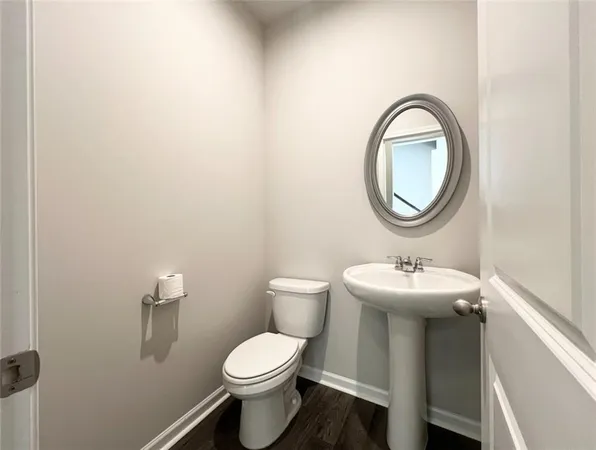 a bathroom with a toilet a sink and a mirror