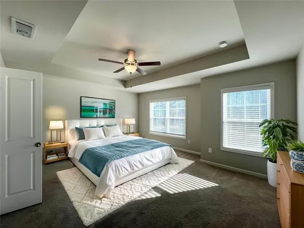 a spacious bedroom with a large bed and a window