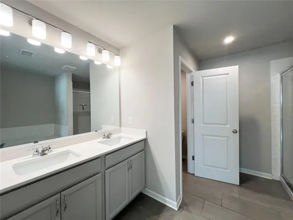 a bathroom with a double vanity sink and a mirror
