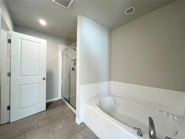 a bathroom with a tub and shower