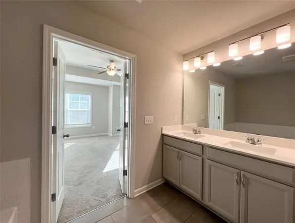 a bathroom with a double vanity sink and a mirror