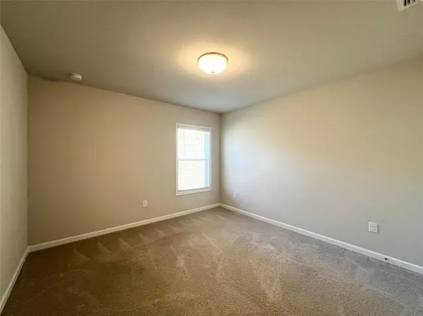 an empty room with a empty space and windows