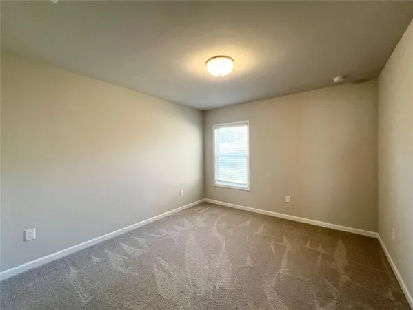 an empty room with a empty space and windows