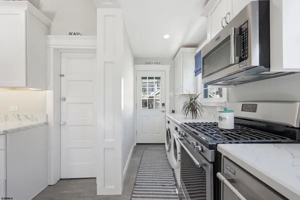 a kitchen with stainless steel appliances a refrigerator and a stove