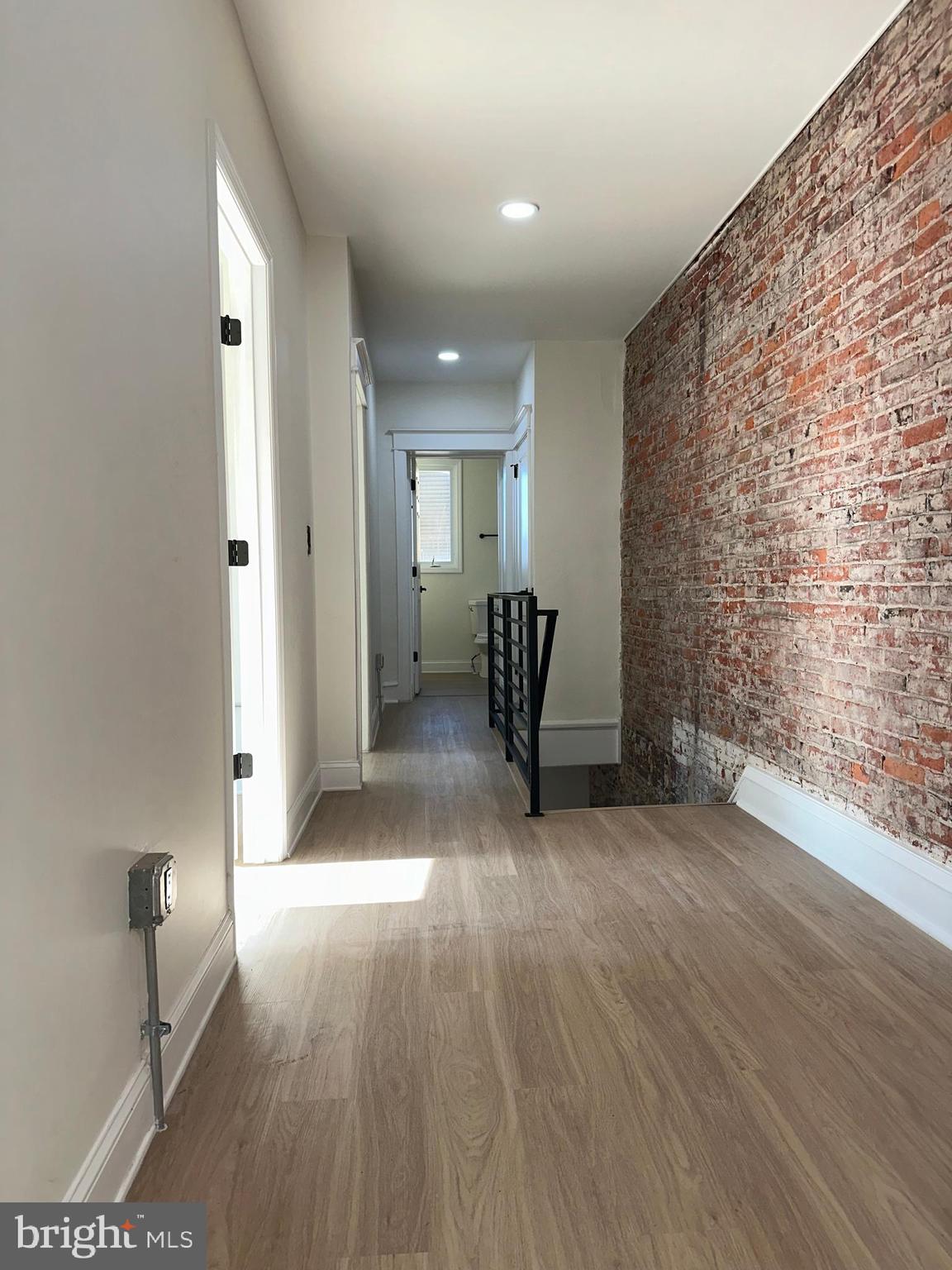 2000 Palethorp Street Philadelphia, PA 19122 - Photo 16 of 38 wooden floor in an empty room with a fireplace