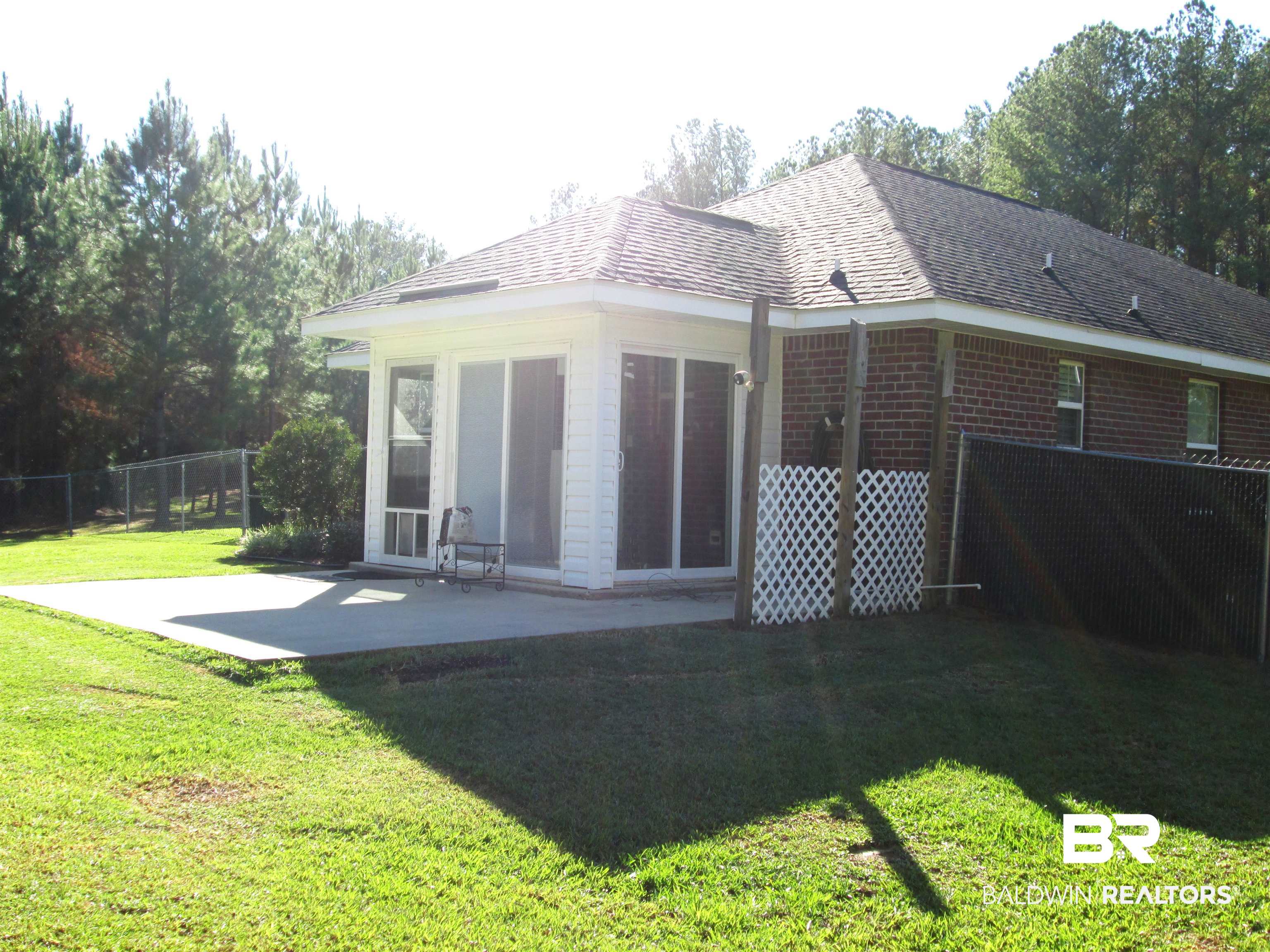 530 Brethren Church Road Fruitdale, AL 36539 - Photo 16 of 24 Rear view of property with a patio and a lawn