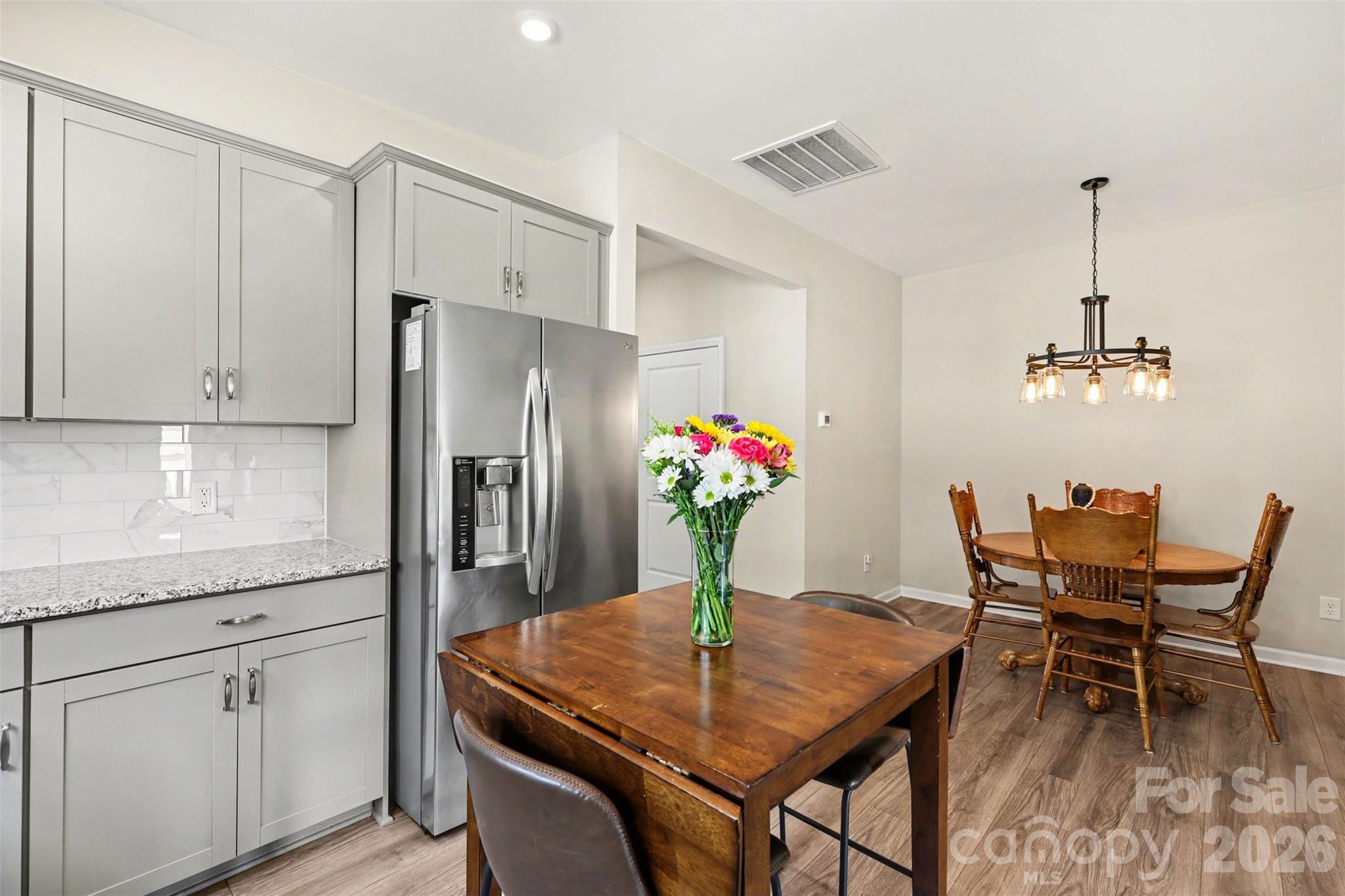 248 Kerri Dawn Lane Locust, NC 28097 - Photo 12 of 25 a view of a kitchen with a table and chairs in it