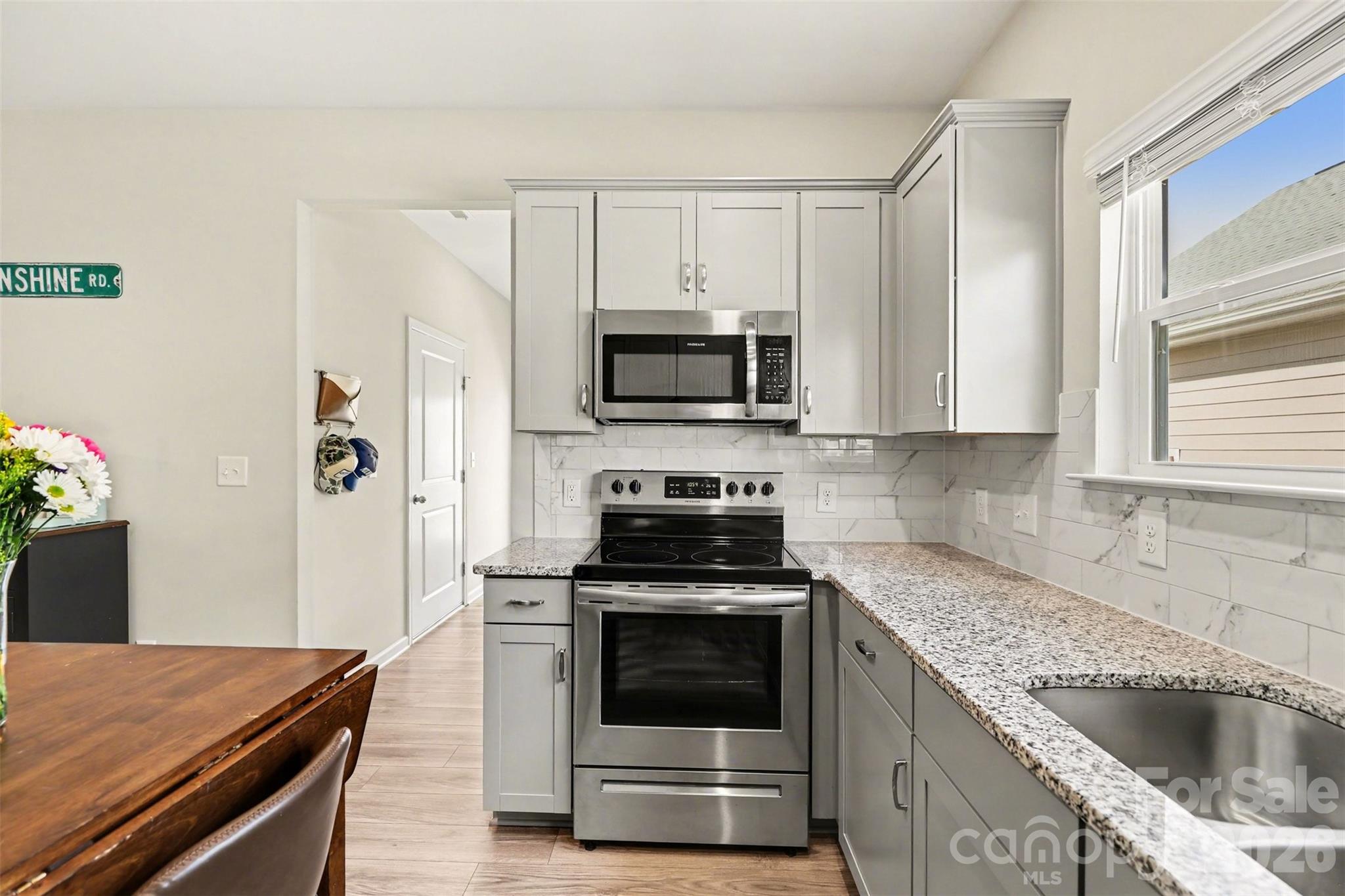 248 Kerri Dawn Lane Locust, NC 28097 - Photo 14 of 25 a kitchen with granite countertop a stove and a microwave