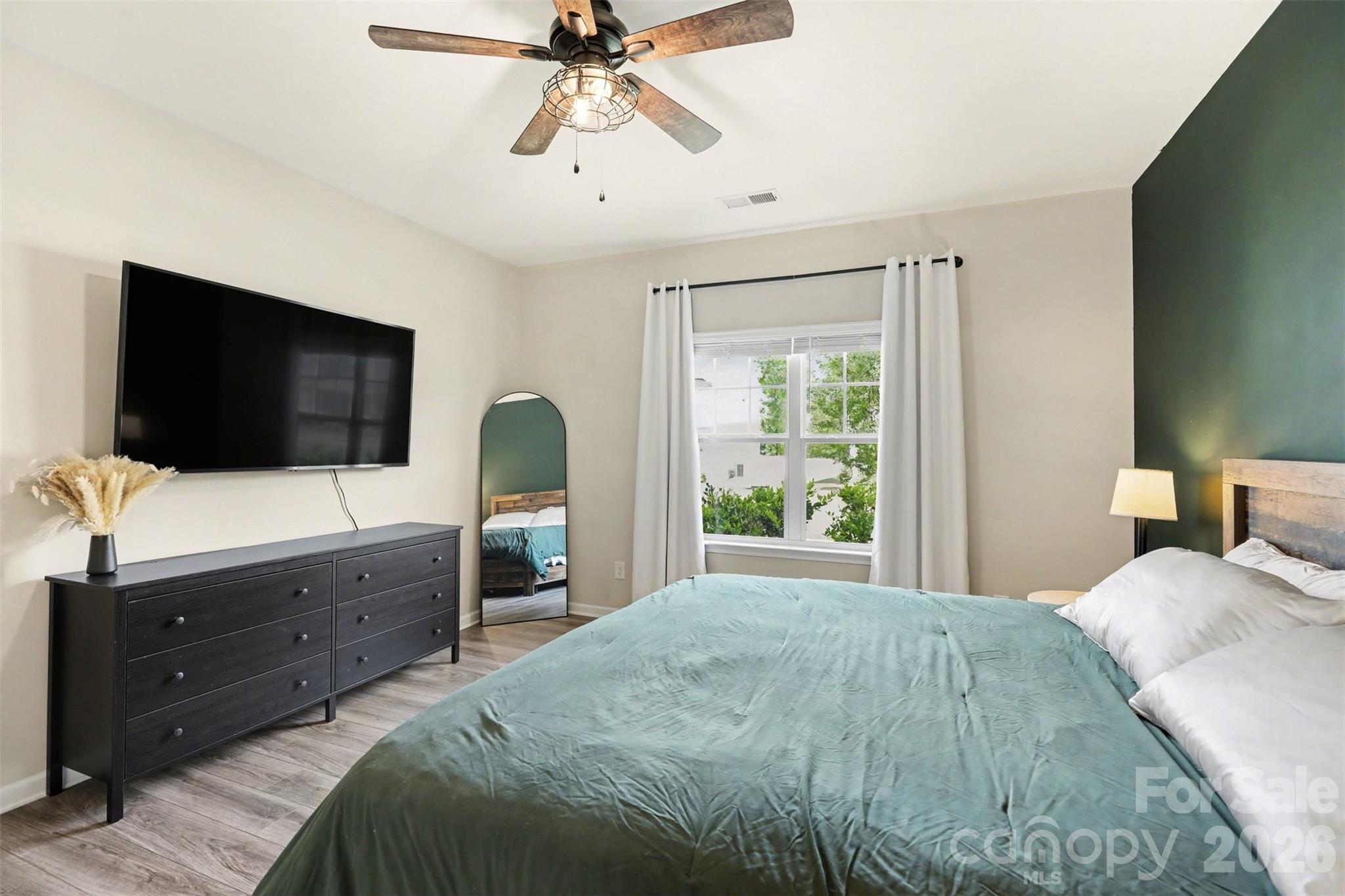 248 Kerri Dawn Lane Locust, NC 28097 - Photo 16 of 25 a bedroom with a bed and a flat screen tv