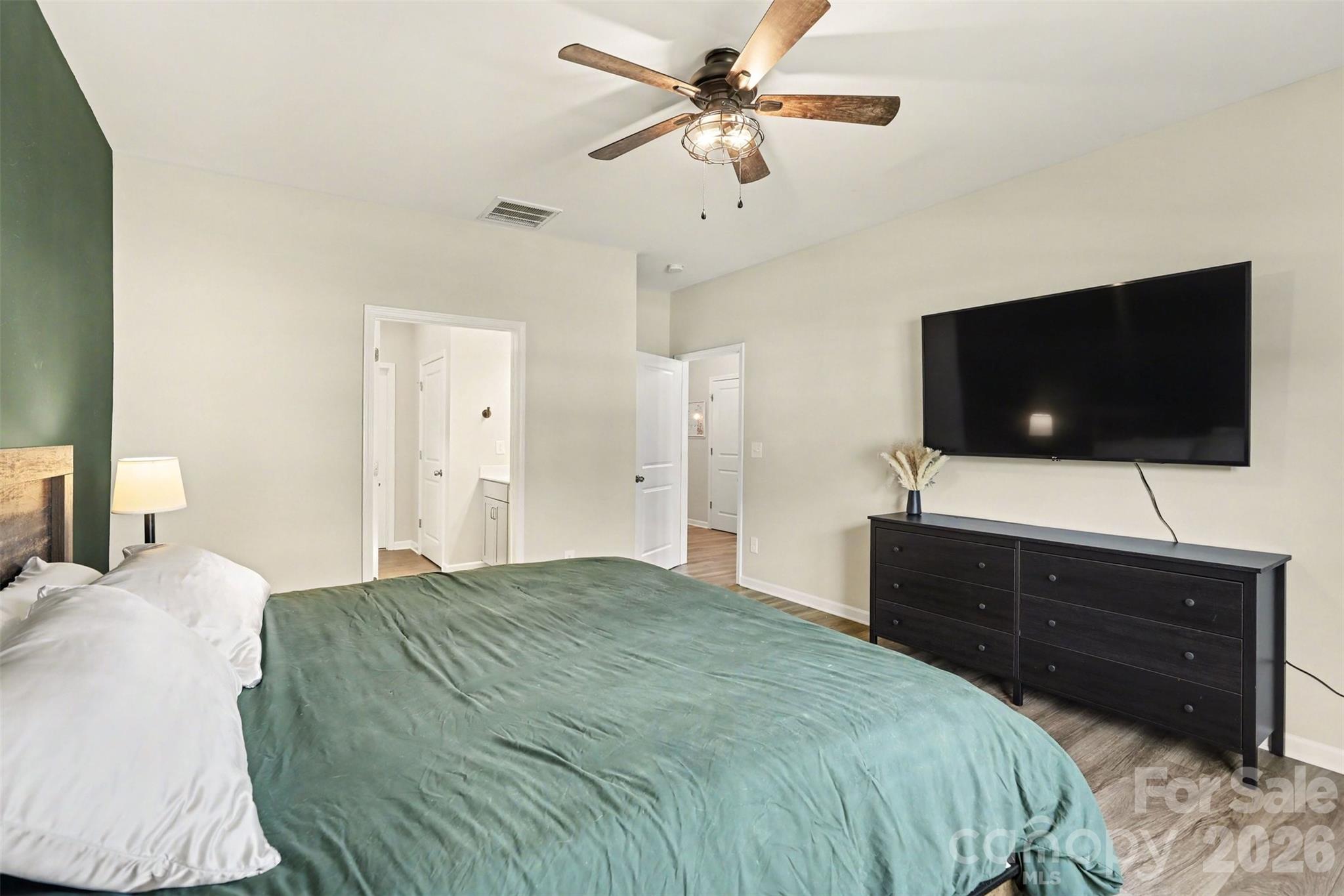 248 Kerri Dawn Lane Locust, NC 28097 - Photo 17 of 25 a bedroom with a bed and a flat screen tv