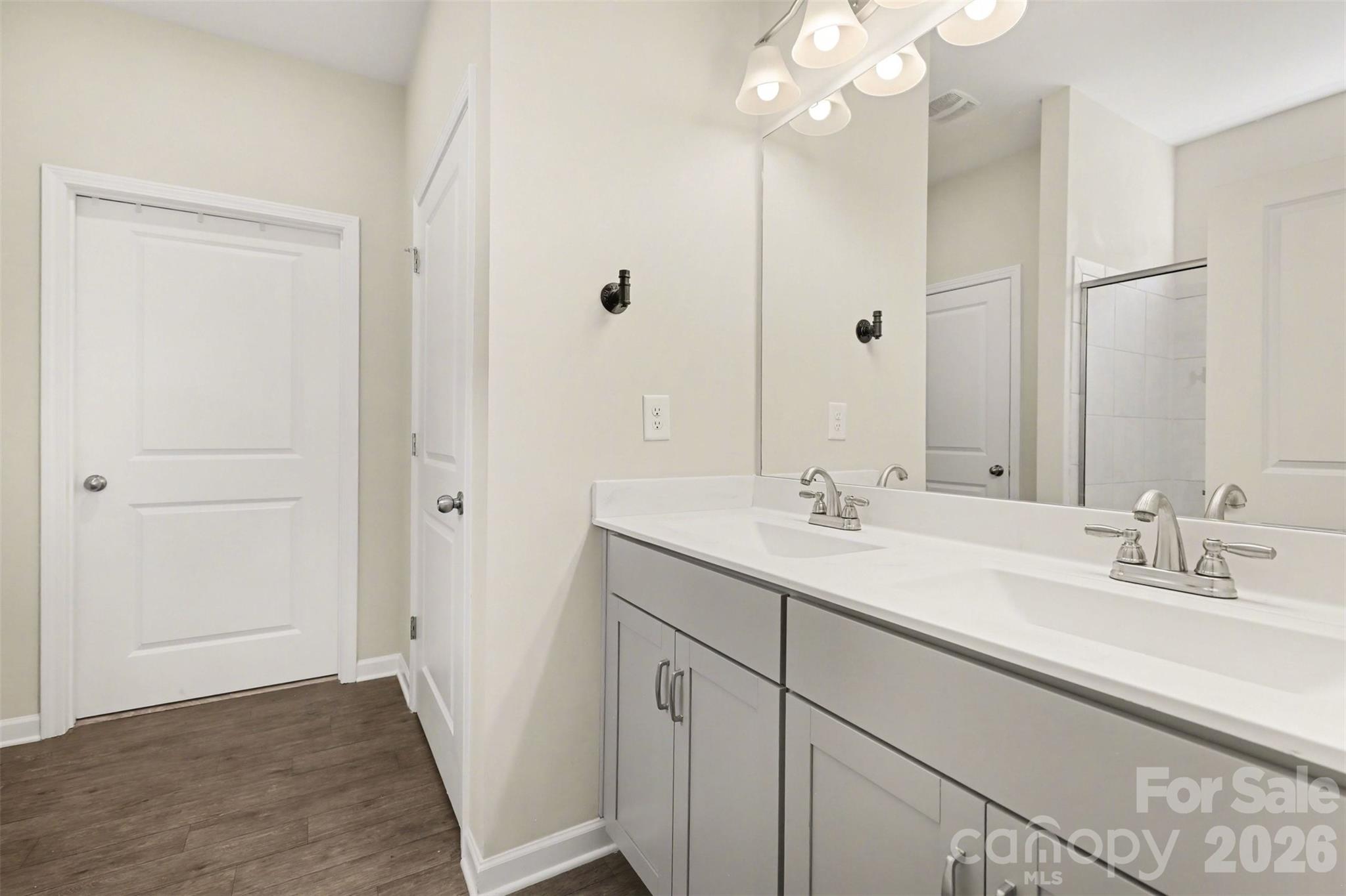 248 Kerri Dawn Lane Locust, NC 28097 - Photo 19 of 25 a bathroom with a double vanity sink and a mirror