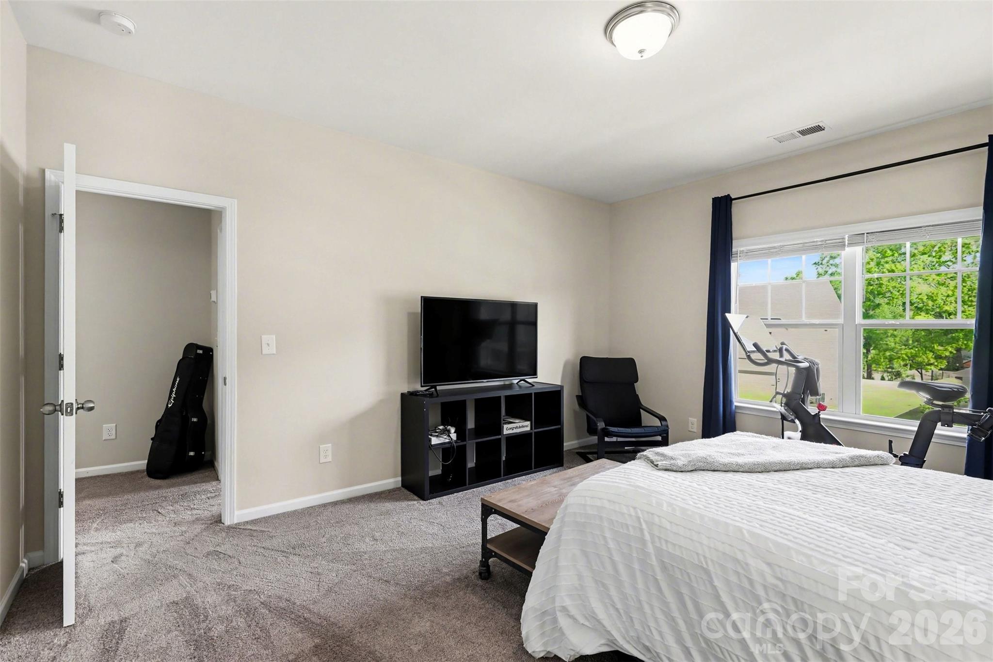 248 Kerri Dawn Lane Locust, NC 28097 - Photo 21 of 25 a bedroom with a bed and a flat tv screen on the dresser