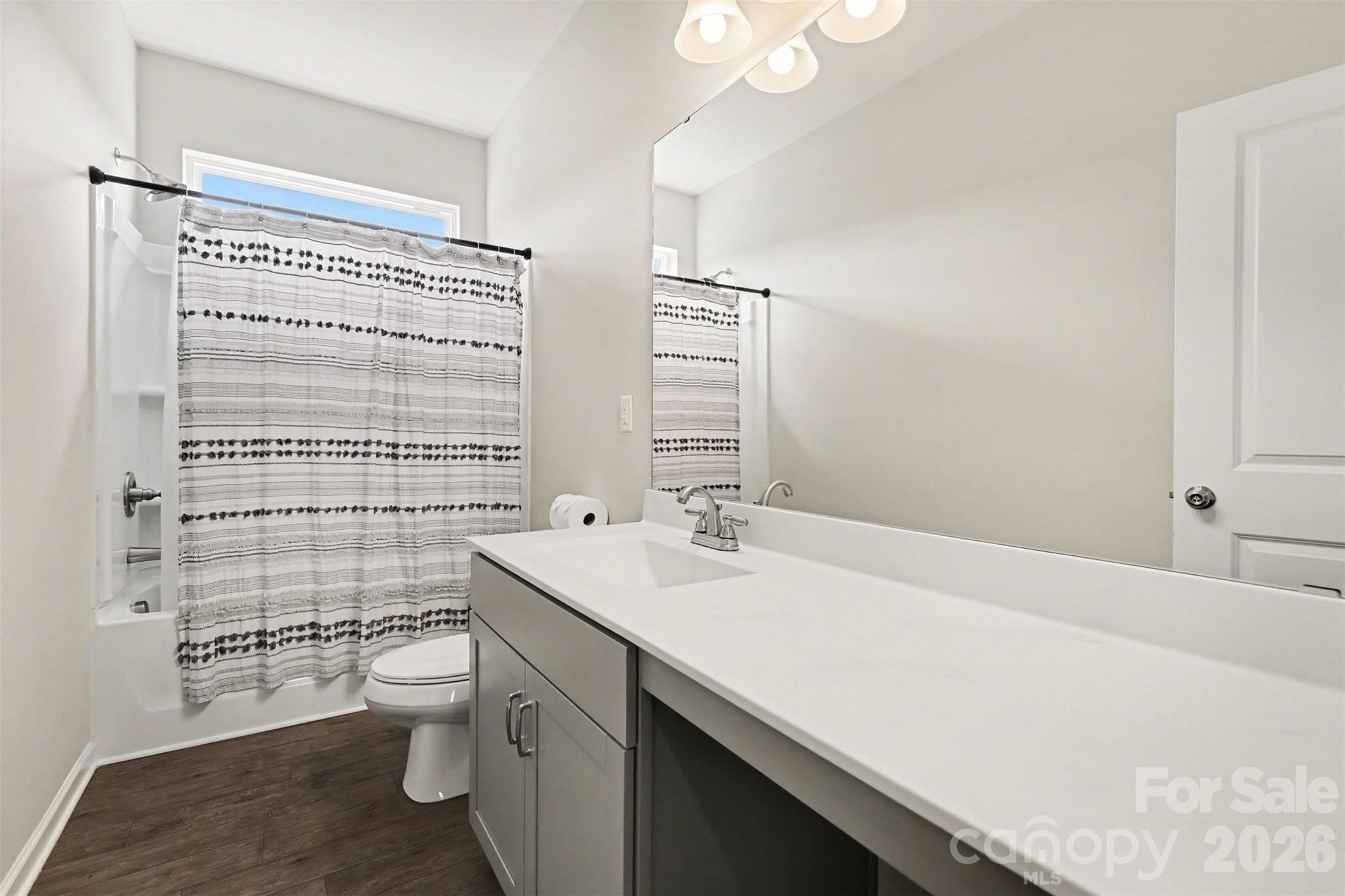 248 Kerri Dawn Lane Locust, NC 28097 - Photo 24 of 25 a bathroom with a sink a toilet and shower curtain