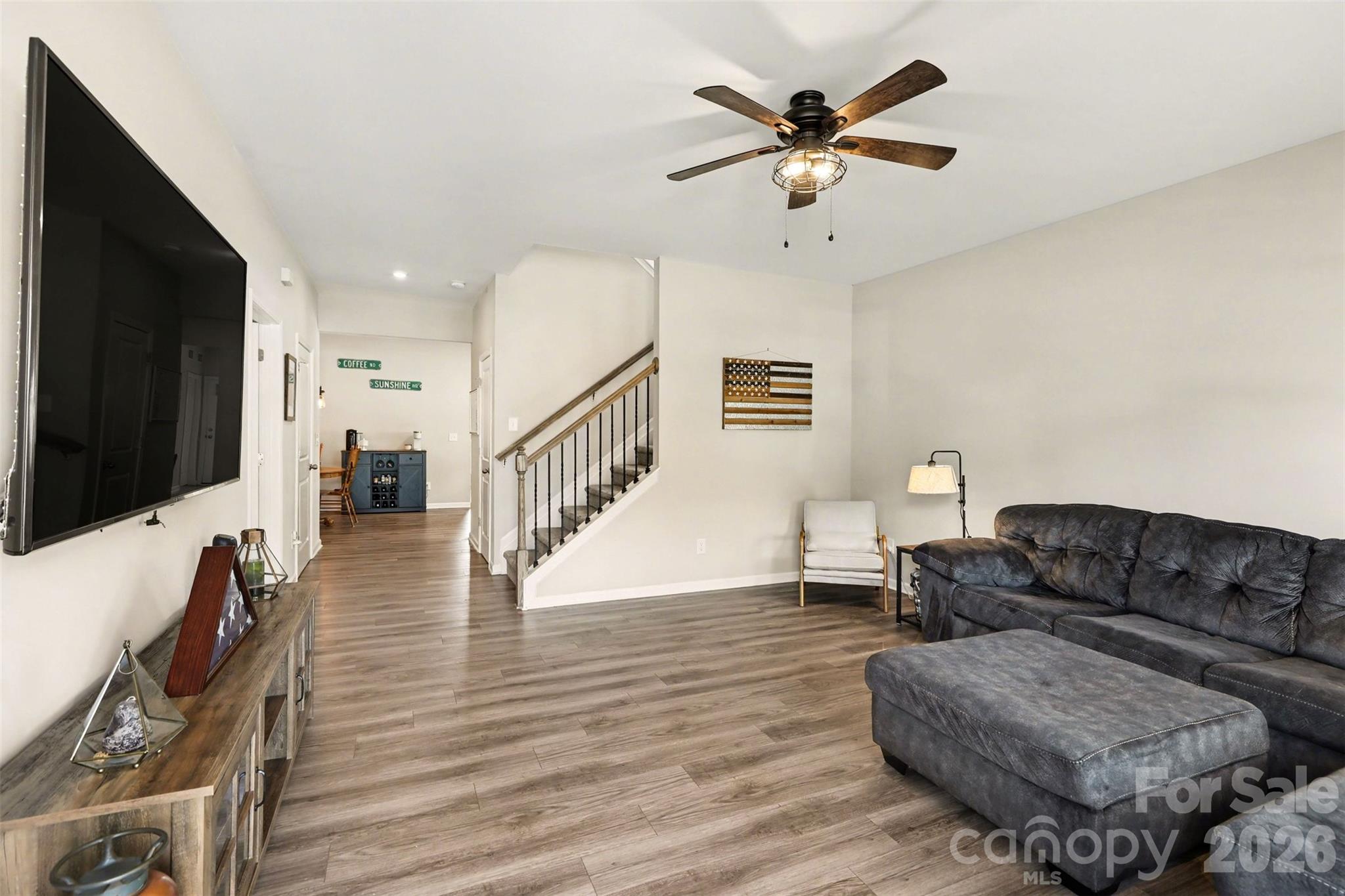 248 Kerri Dawn Lane Locust, NC 28097 - Photo 6 of 25 a living room with furniture and a flat screen tv