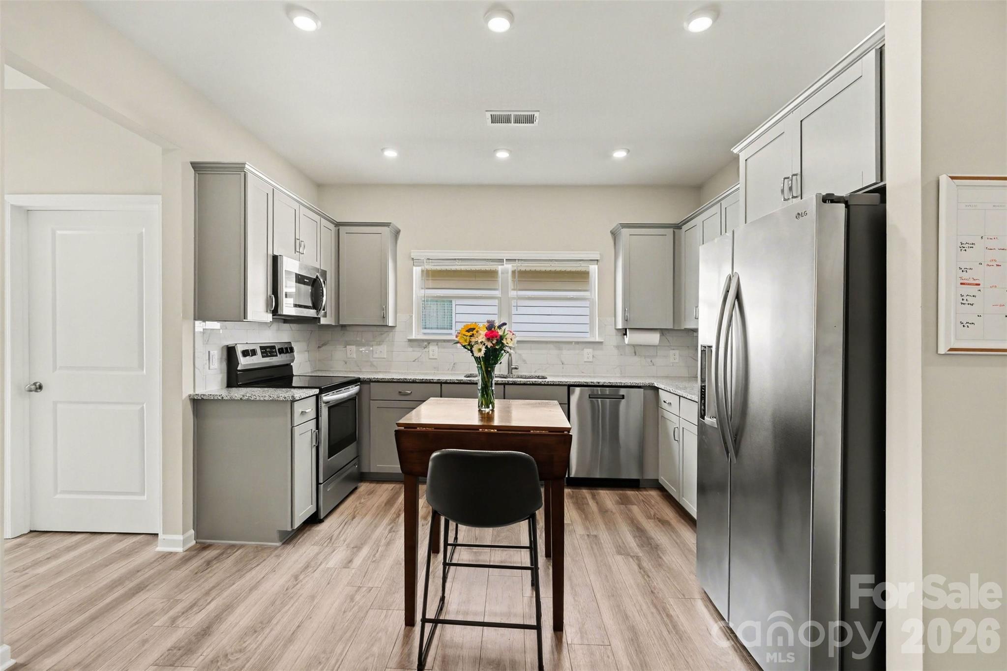 248 Kerri Dawn Lane Locust, NC 28097 - Photo 10 of 25 a kitchen with kitchen island a counter top space stainless steel appliances and cabinets