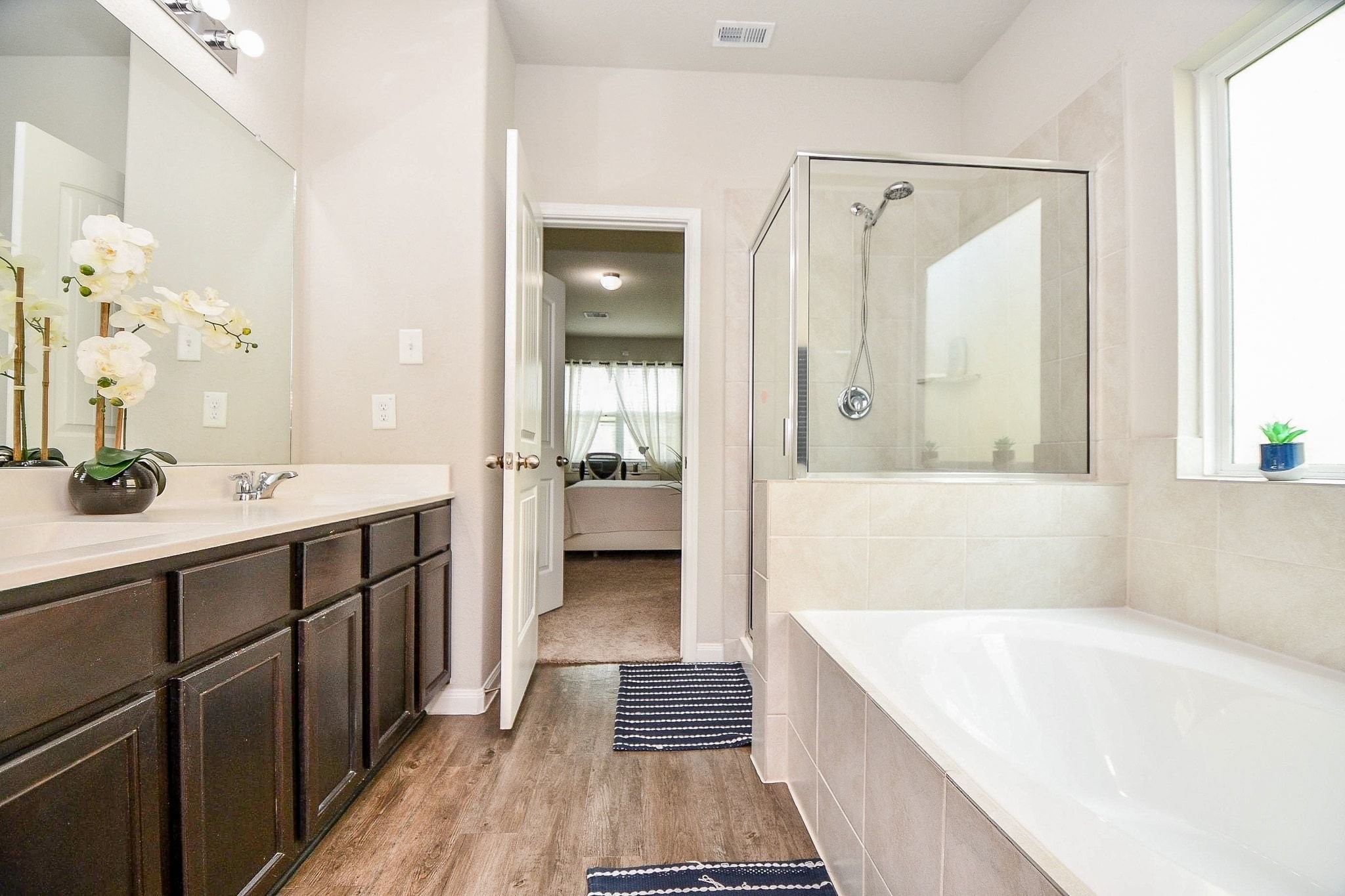 4834 Purple Wisteria Lane Spring, TX 77373 - Photo 15 of 31 Primary bathroom features a tub and separate standing shower.
