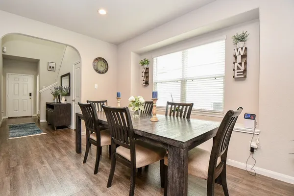 a dining room with furniture and window