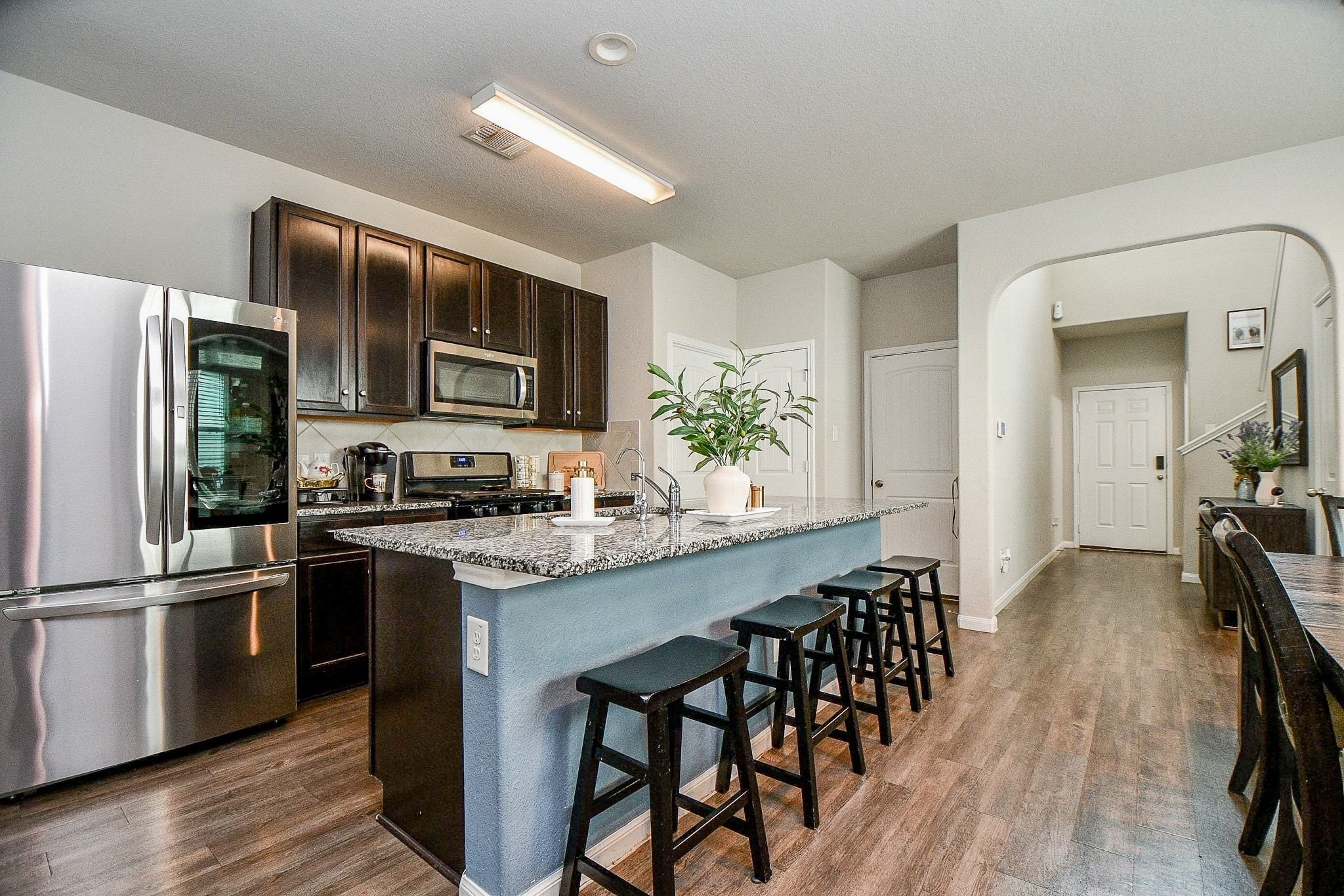 4834 Purple Wisteria Lane Spring, TX 77373 - Photo 7 of 31 Dark brown cabinetry and stainless steel appliances in the kitchen.