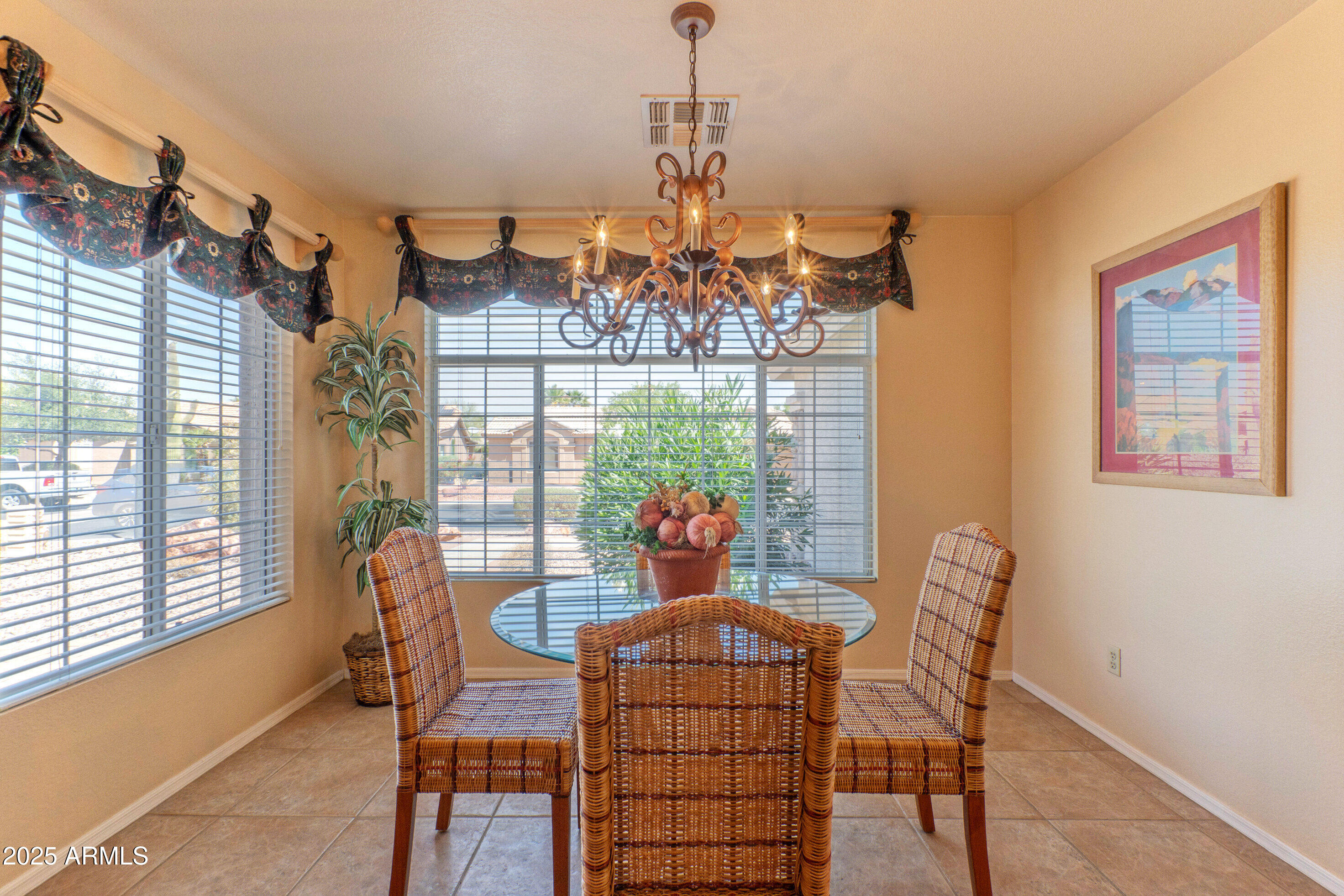 15371 Piccadilly Road Goodyear, AZ 85395 - Photo 12 of 26 a view of a dining room with furniture wooden floor and chandelier