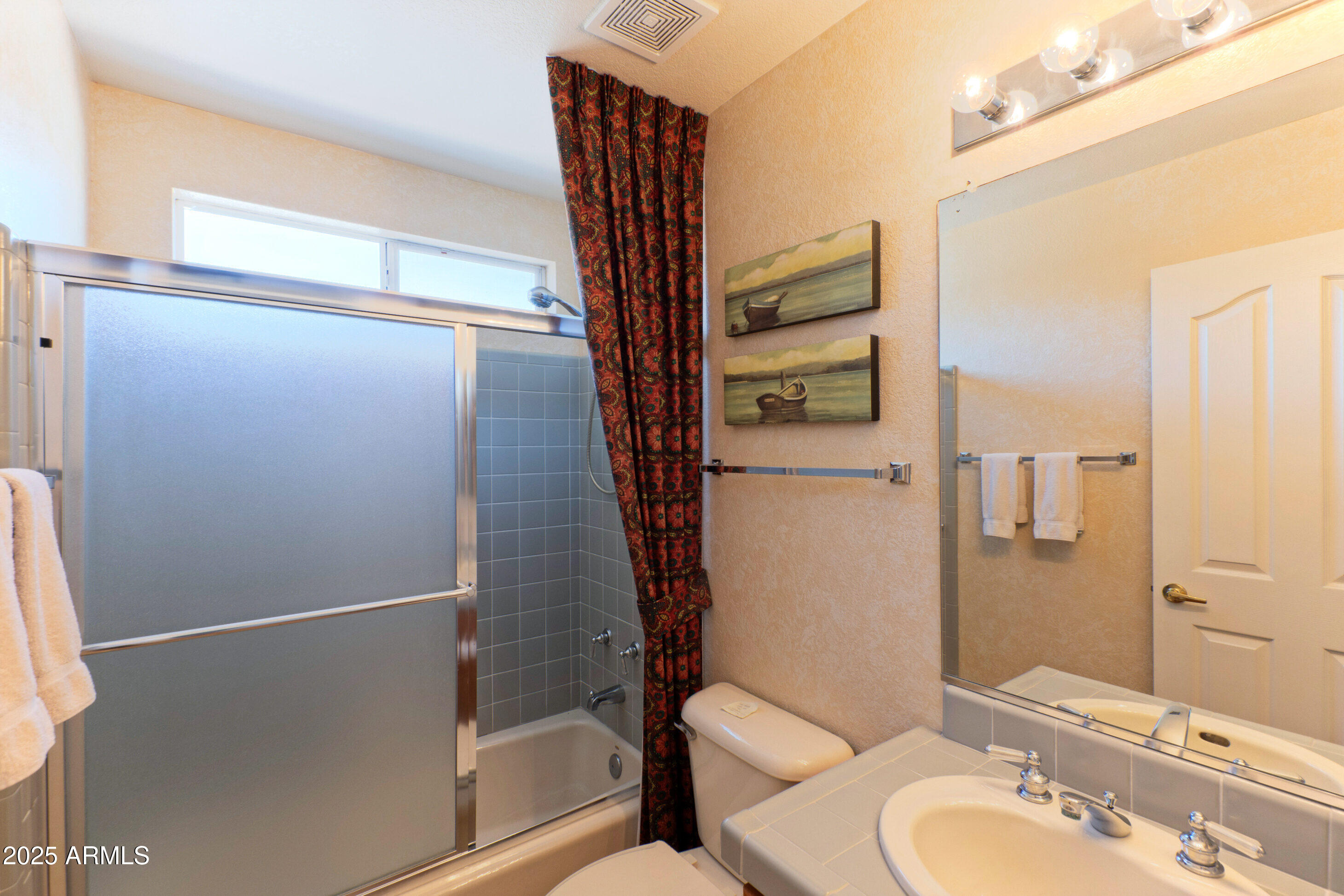15371 Piccadilly Road Goodyear, AZ 85395 - Photo 16 of 26 a bathroom with a sink a toilet and shower