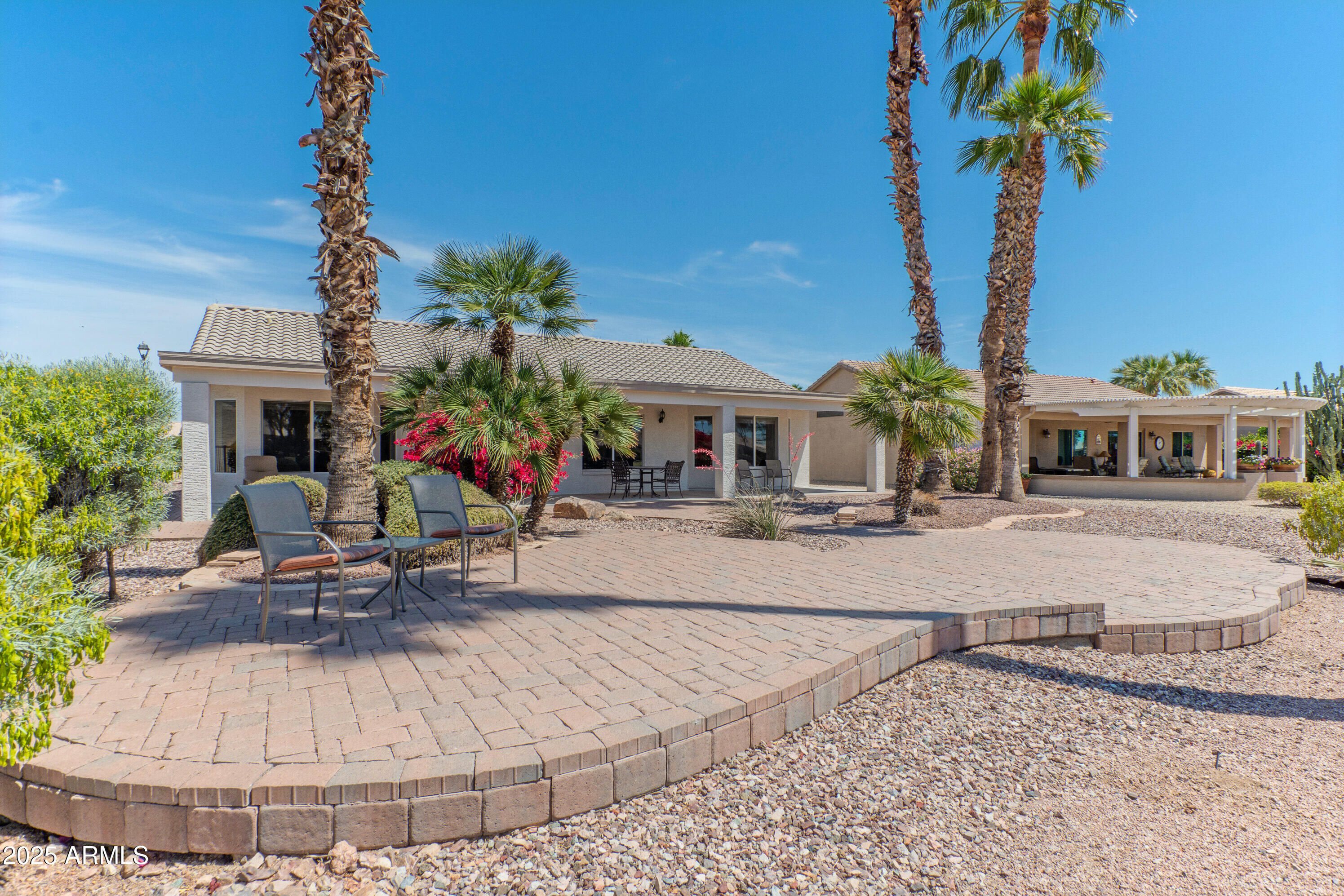 15371 Piccadilly Road Goodyear, AZ 85395 - Photo 20 of 26 a view of a house with sitting area and a yard