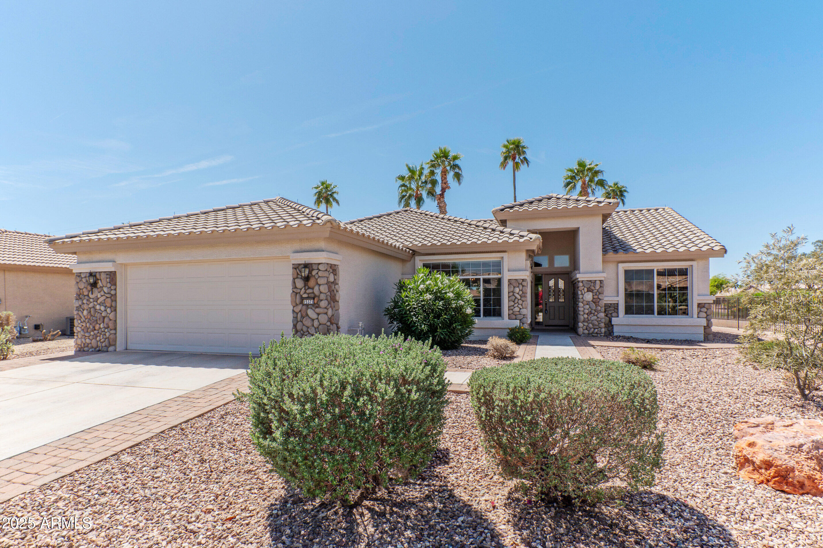 15371 Piccadilly Road Goodyear, AZ 85395 - Photo 2 of 26 a front view of a house with garden