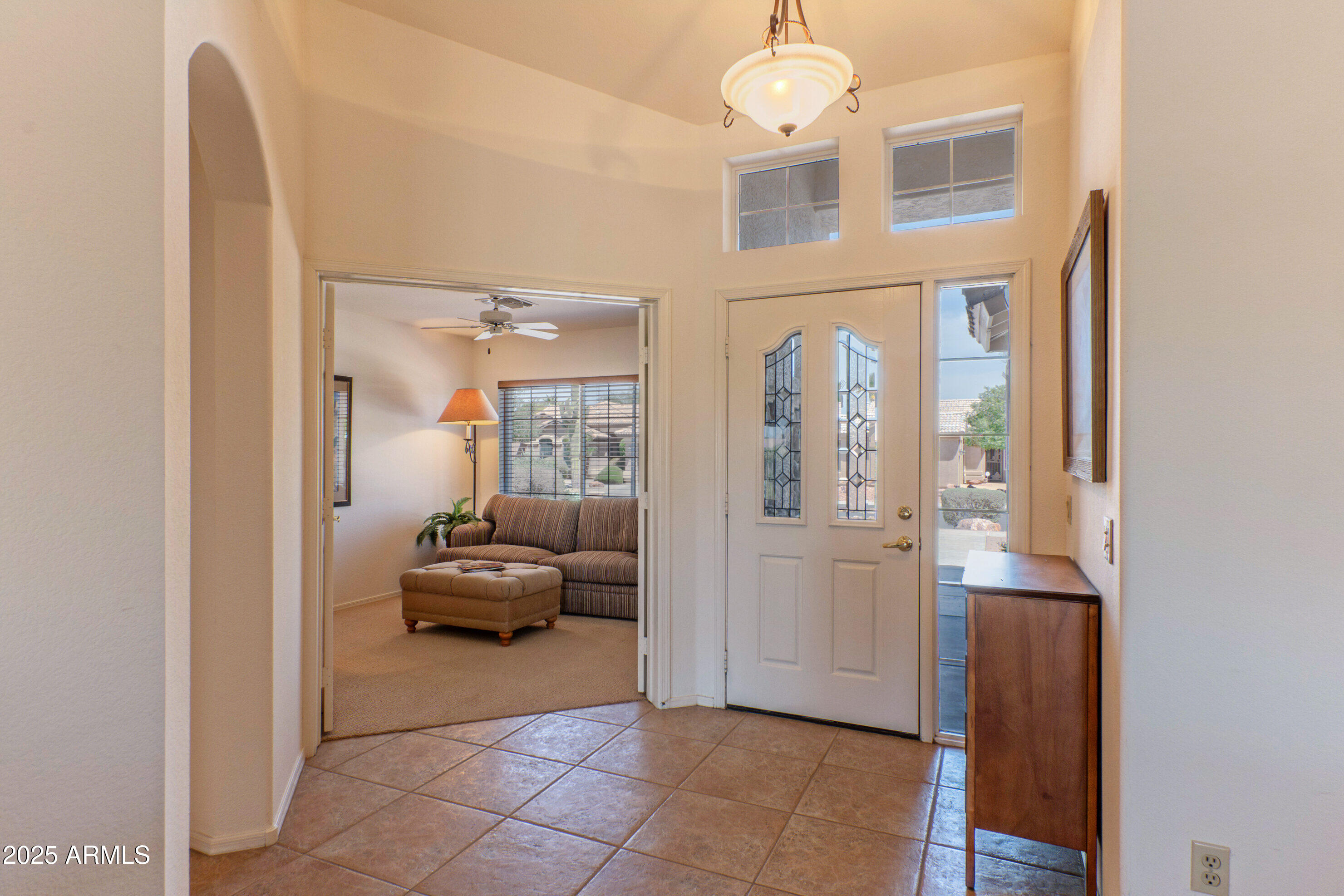 15371 Piccadilly Road Goodyear, AZ 85395 - Photo 3 of 26 a hallway with a furniture and a livingroom view