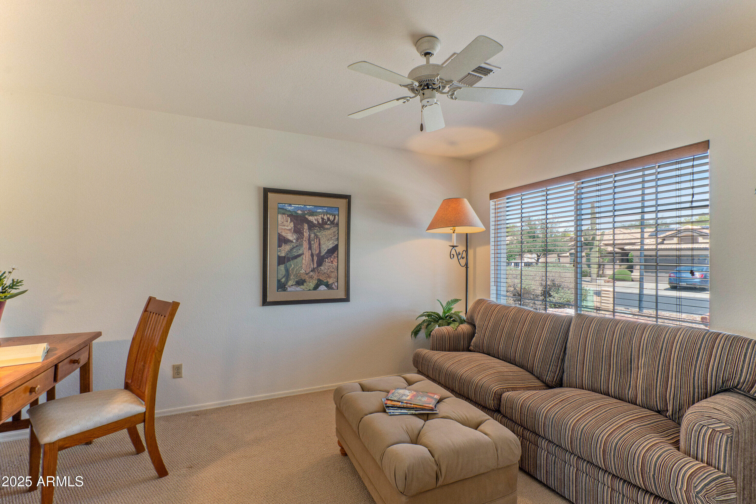 15371 Piccadilly Road Goodyear, AZ 85395 - Photo 4 of 26 a living room with furniture and a large window