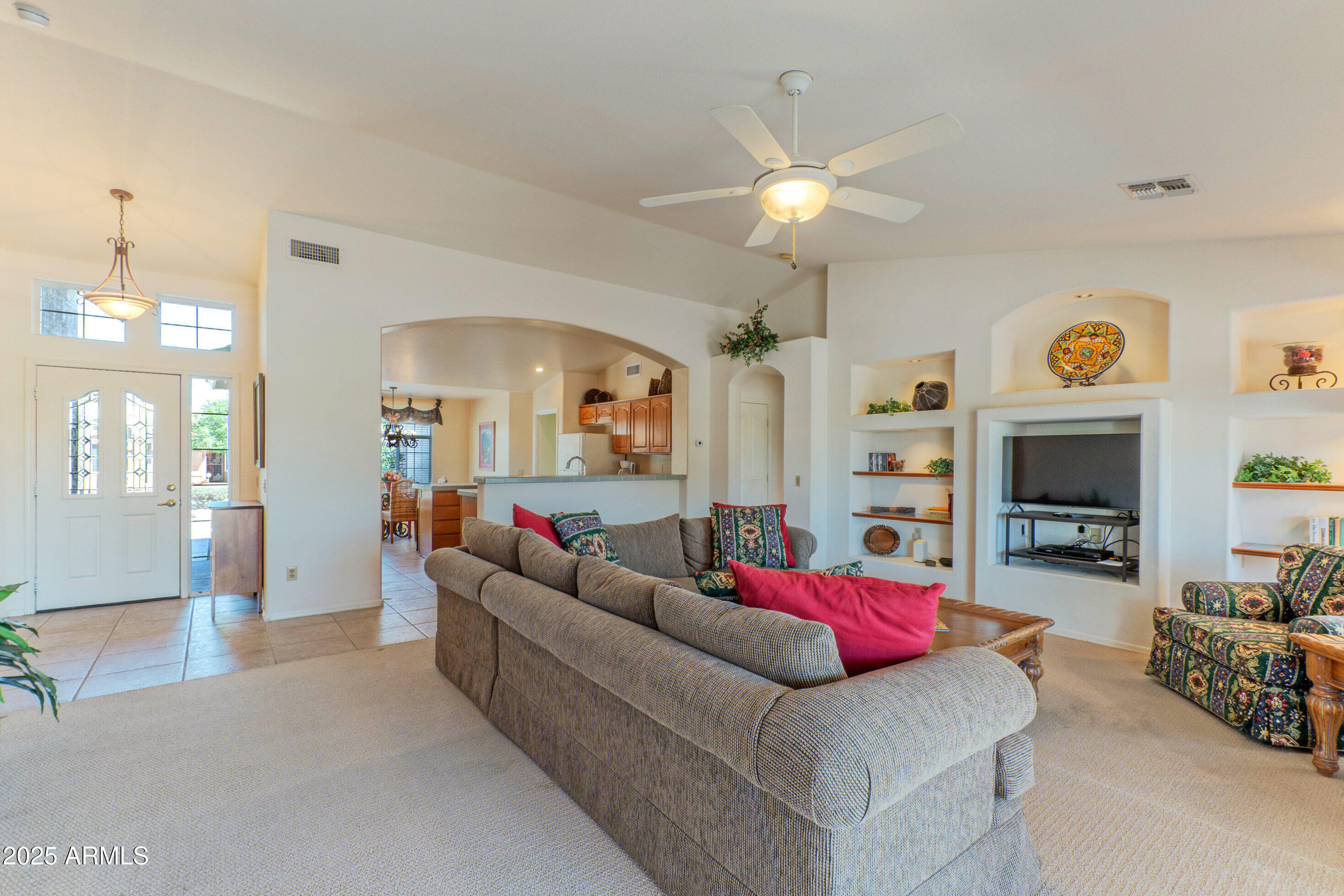 15371 Piccadilly Road Goodyear, AZ 85395 - Photo 5 of 26 a living room with furniture and a fireplace